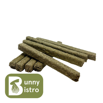 Pile of Bunny Bistro Herby Sticks, hay stick treats with real herbs for small pets. Side view.