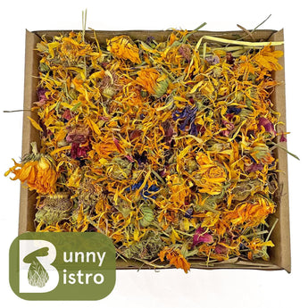 Bunny Bistro Flower Forage Tray. Dried grass topped with dried marigold, hibiscus, rose, and blue mallow flowers for small pets.