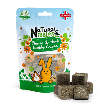Natural Nibbles Flower & Herb Nibble Cubes. A stack of forage cubes next to blue pouch pack, for small pets.