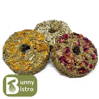 Bunny Bistro Mixed Forage Donuts 3 Pack, dried grass donuts topped with chamomile, pea flakes and mint, and rose.
