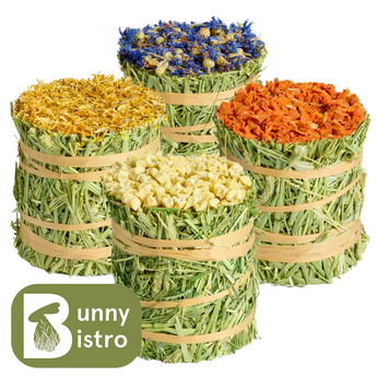 Natural Nibbles Timothy Hay Roll Mixed Pack, topped with cornflower, marigold, carrot and apple for small pets.
