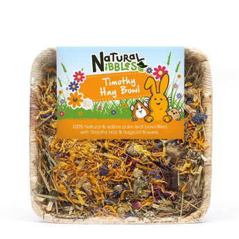 Natural Nibbles Timothy Hay Bowl, an edible palm bowl filled with hay and dried flowers.